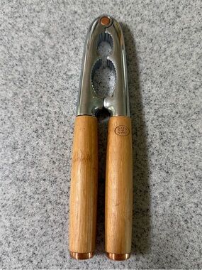 Dash of That Nut Cracker featuring natural bamboo handles and copper accents